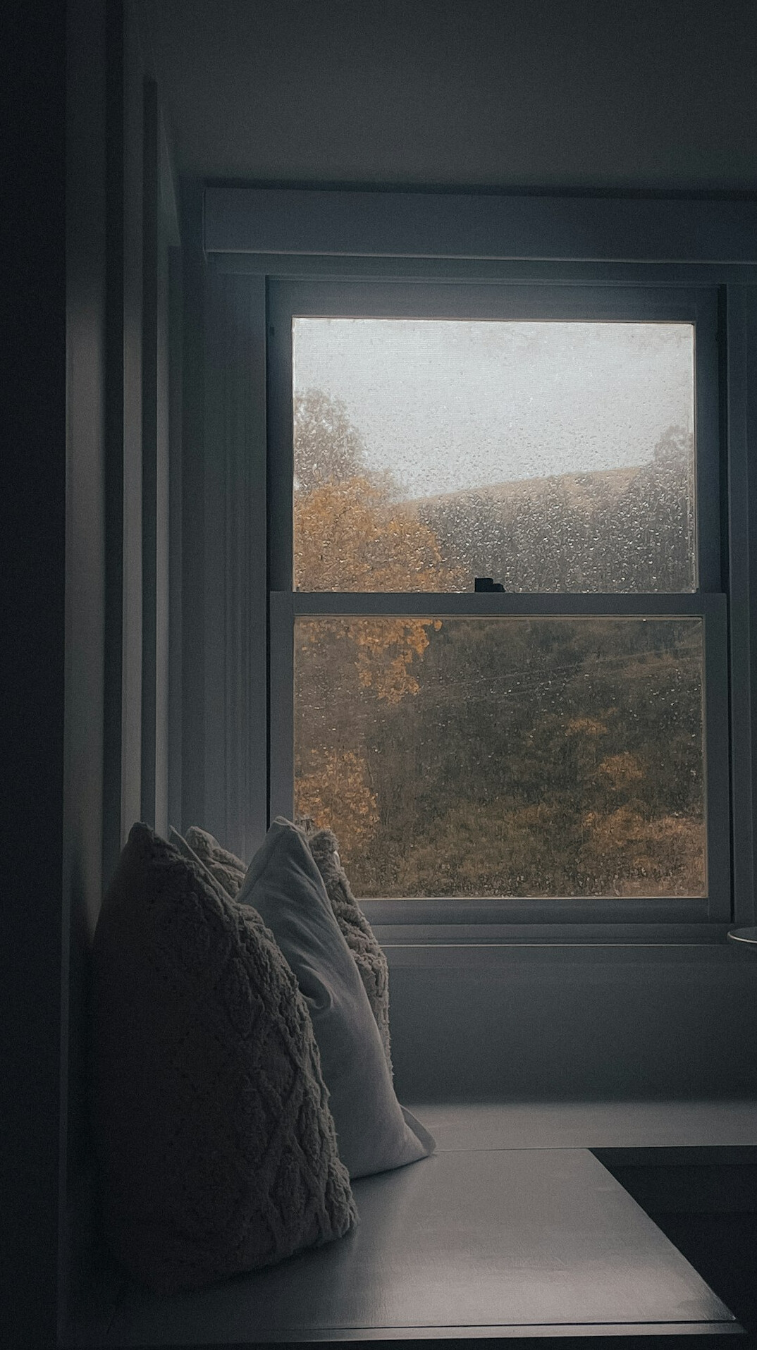 Vintage typewriter on a desk near a rainy window