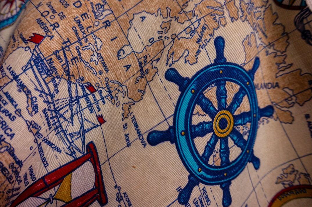 Old map and compass on a wooden table